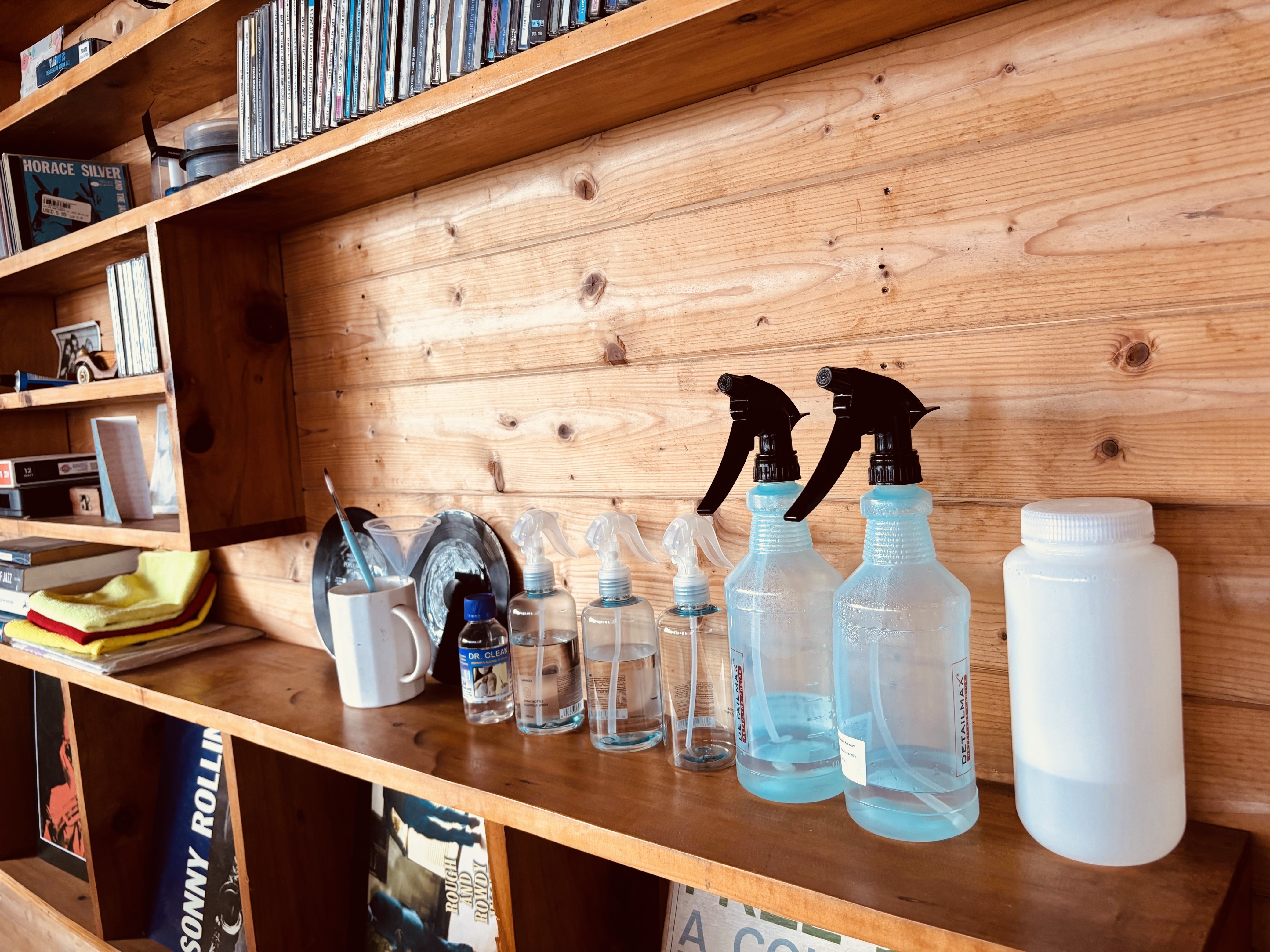 Records and cleaning tools on a shelf